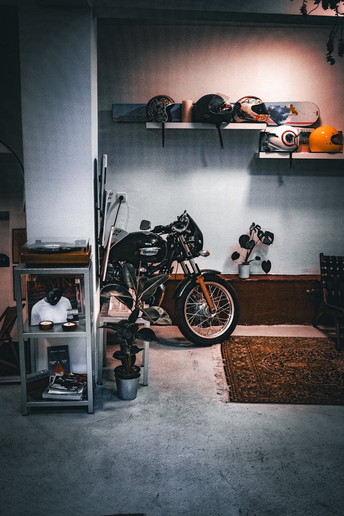 A cozy indoor setup featuring a motorcycle, helmets, and decor. Ideal for motorbike enthusiasts.